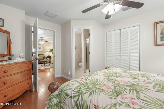 bedroom featuring ceiling fan, ensuite bath, light wood-type flooring, and a closet