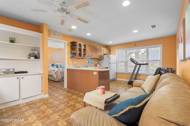 living room featuring light parquet floors and ceiling fan