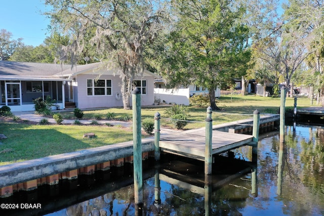 view of dock featuring a water view and a yard