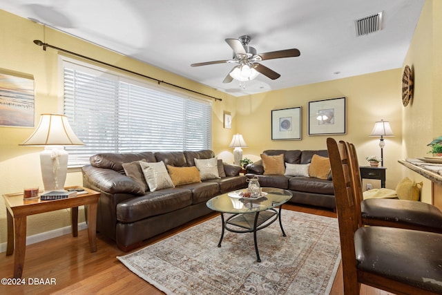 living room featuring light hardwood / wood-style floors and ceiling fan