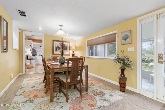 dining room with light colored carpet