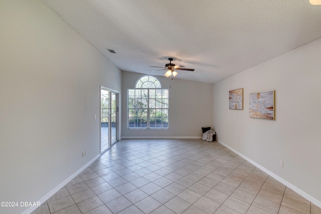 tiled spare room featuring ceiling fan and a textured ceiling