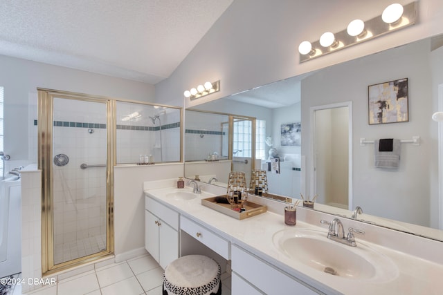 bathroom with vanity, tile patterned floors, a textured ceiling, a shower with shower door, and washer / clothes dryer