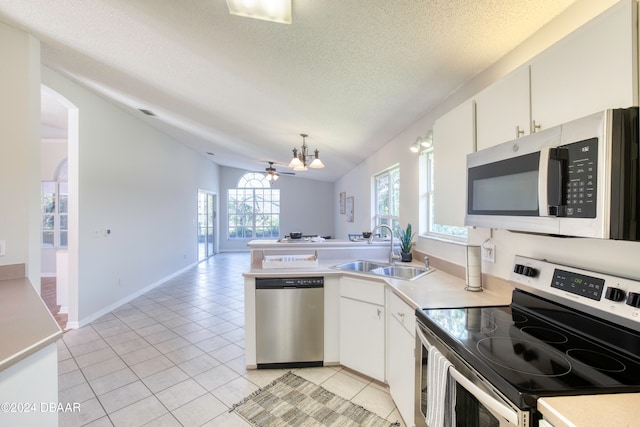 kitchen featuring white cabinetry, sink, lofted ceiling, and stainless steel appliances