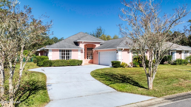 ranch-style house featuring a garage and a front lawn