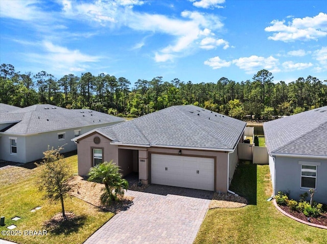 5583 Estero Loop, Port Orange, FL 32128 - view of front facade featuring an attached garage, decorative driveway, and stucco siding