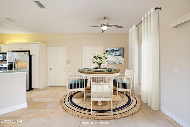 dining space featuring light tile patterned floors and ceiling fan