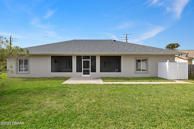 rear view of house featuring a yard