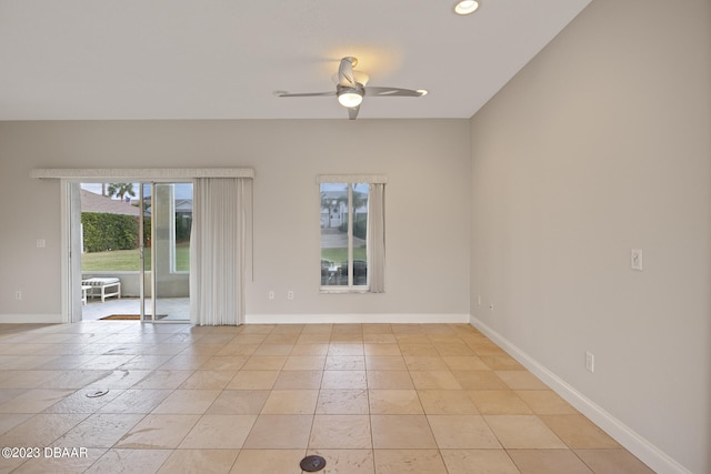 tiled spare room featuring ceiling fan