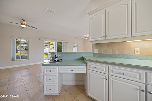 kitchen with ceiling fan, white cabinetry, light tile patterned floors, and backsplash