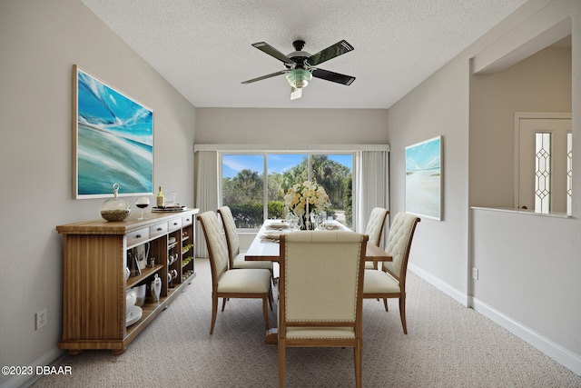 dining space featuring carpet, a textured ceiling, and ceiling fan