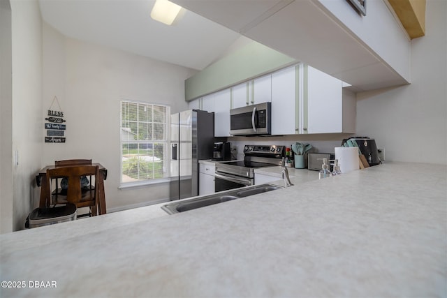 2953 Wild Pecan Ct, Port Orange, FL 32129 - kitchen featuring appliances with stainless steel finishes, light countertops, and white cabinetry