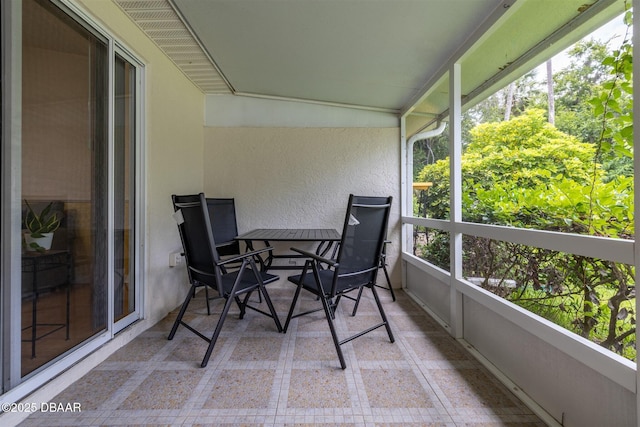 2953 Wild Pecan Ct, Port Orange, FL 32129 - sunroom featuring tile patterned floors, a textured wall, and outdoor dining area