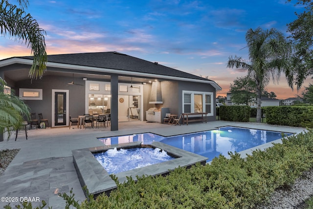 6294 W Fallsgrove Ln, Port Orange, FL 32128 - back of house at dusk with ceiling fan, stucco siding, an outdoor pool, a patio, and an in-ground hot tub