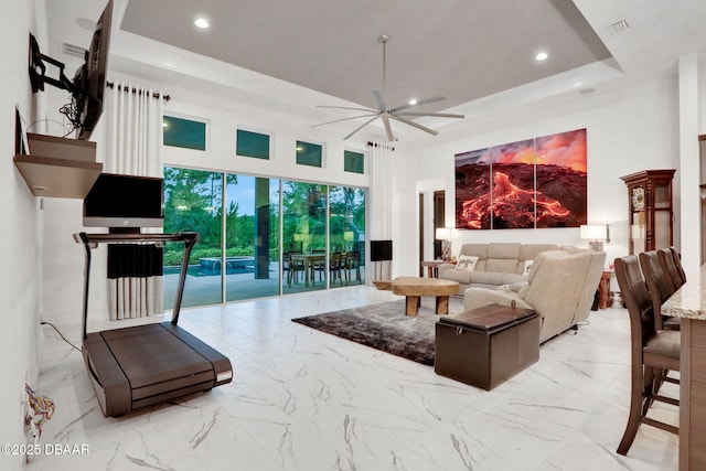6294 W Fallsgrove Ln, Port Orange, FL 32128 - living area featuring a ceiling fan, recessed lighting, a tray ceiling, a towering ceiling, and marble finish flooring