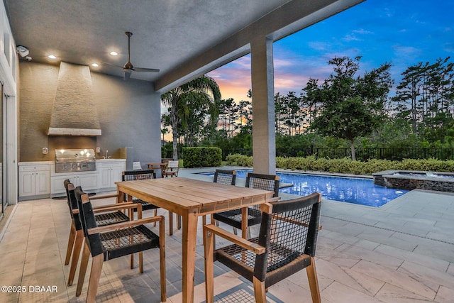 6294 W Fallsgrove Ln, Port Orange, FL 32128 - patio terrace at dusk with an outdoor kitchen, outdoor dining area, ceiling fan, a pool with connected hot tub, and a patio area