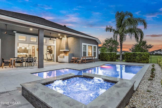 6294 W Fallsgrove Ln, Port Orange, FL 32128 - pool at dusk featuring a fenced backyard, a ceiling fan, a patio area, an in-ground hot tub, and outdoor dining area