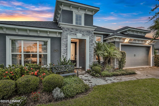 6294 W Fallsgrove Ln, Port Orange, FL 32128 - italianate-style house featuring driveway, stucco siding, stone siding, and a shingled roof