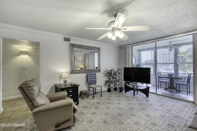 329 Wilder Blvd Unit C103, Daytona Beach, FL 32114 - living room featuring a textured ceiling, a wall of windows, ceiling fan, crown molding, and tile patterned floors