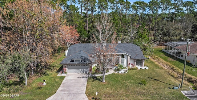 view of front of property featuring driveway, a chimney, and a front yard