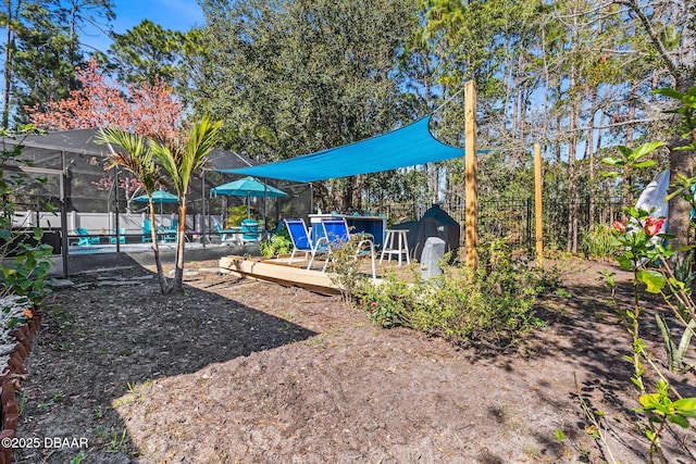 view of playground with a wooden deck, a lanai, a fenced in pool, and fence