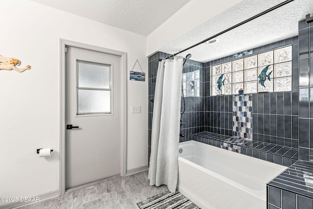 bathroom with shower / tub combo with curtain and a textured ceiling