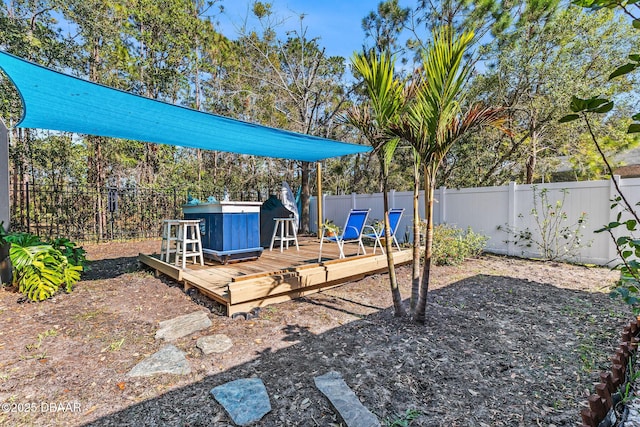 view of yard featuring a fenced backyard and a wooden deck