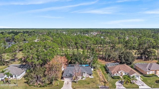 birds eye view of property featuring a forest view and a residential view