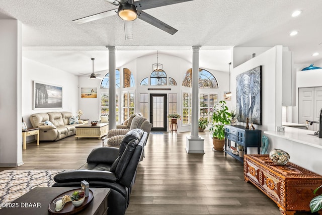 living area featuring a wealth of natural light, wood finished floors, and decorative columns