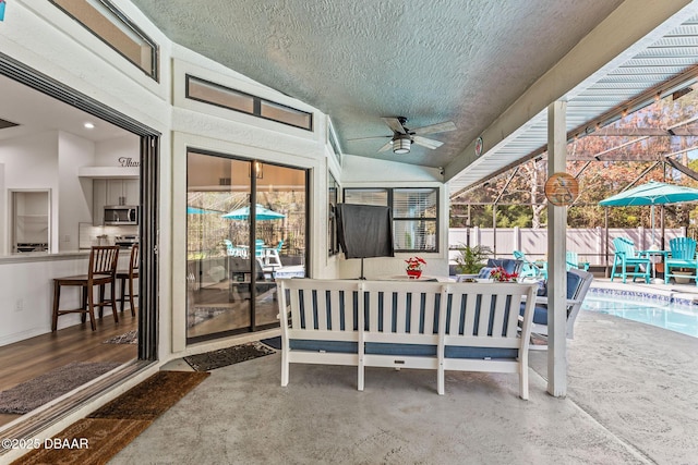 view of patio / terrace featuring a ceiling fan, a fenced in pool, glass enclosure, fence, and outdoor lounge area