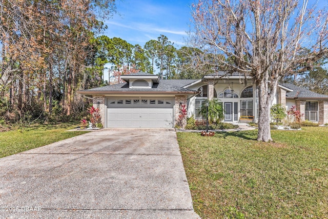 view of front of home featuring brick siding, an attached garage, and a front lawn