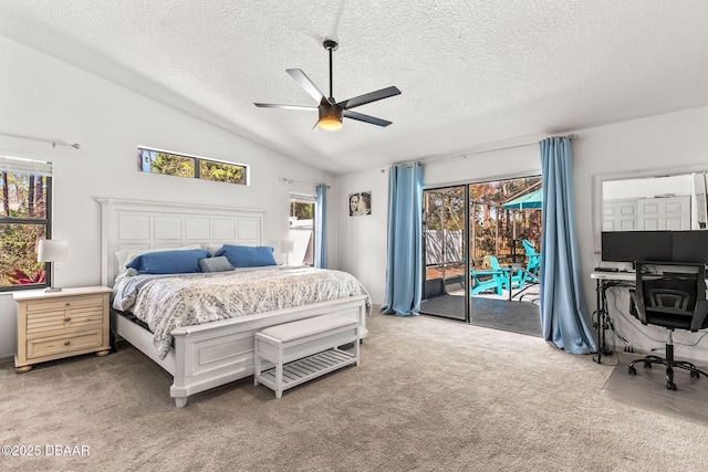 carpeted bedroom featuring access to exterior, vaulted ceiling, a textured ceiling, and a ceiling fan