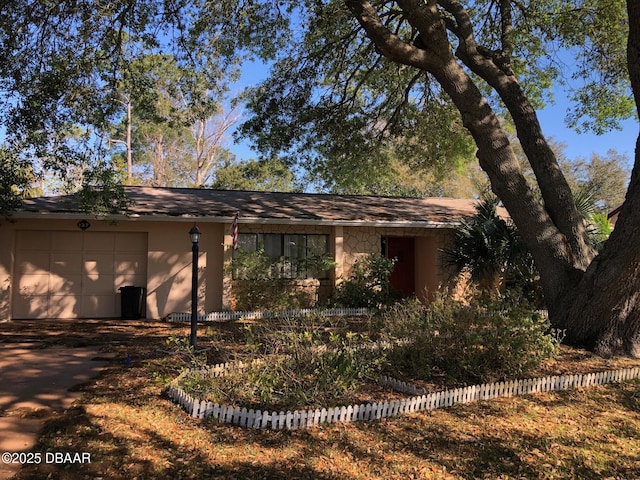 view of front facade with stucco siding and an attached garage