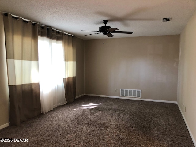 unfurnished room with a ceiling fan, carpet, visible vents, and a textured ceiling