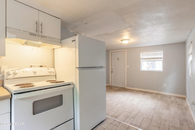 kitchen featuring white appliances, white cabinetry, and light hardwood / wood-style flooring