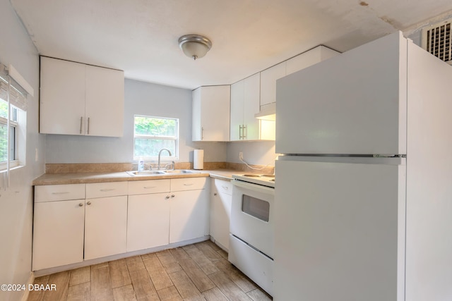 kitchen with white cabinetry, white appliances, sink, and plenty of natural light