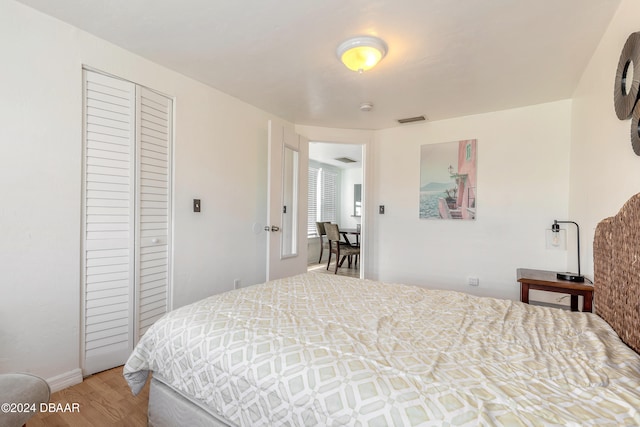 bedroom with hardwood / wood-style floors and a closet