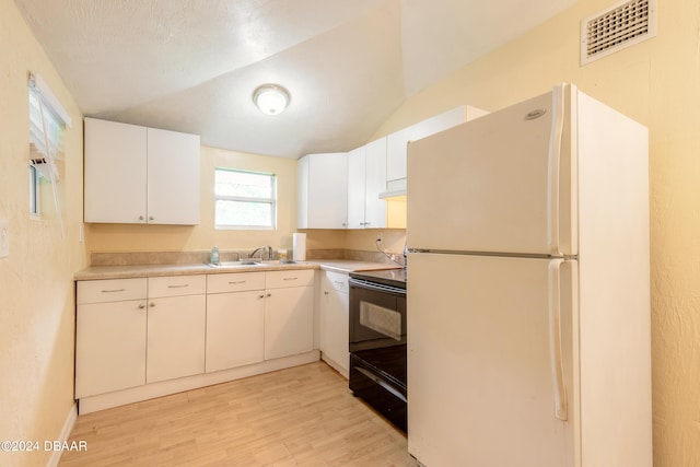 kitchen featuring light hardwood / wood-style floors, white cabinetry, black / electric stove, white refrigerator, and vaulted ceiling