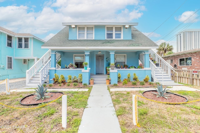 bungalow-style home featuring a porch and a front yard