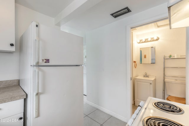 bathroom with tile patterned flooring and sink