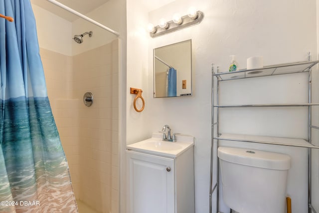 bathroom featuring walk in shower, vanity, and toilet