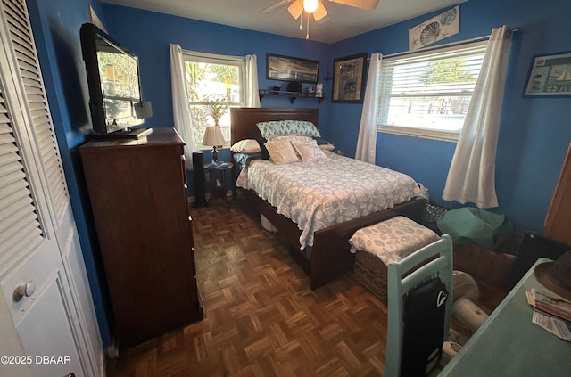 bedroom featuring ceiling fan and dark parquet floors