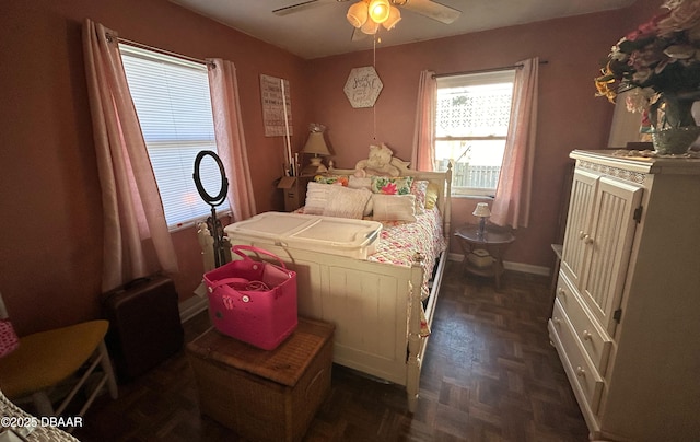 bedroom featuring ceiling fan and dark parquet floors