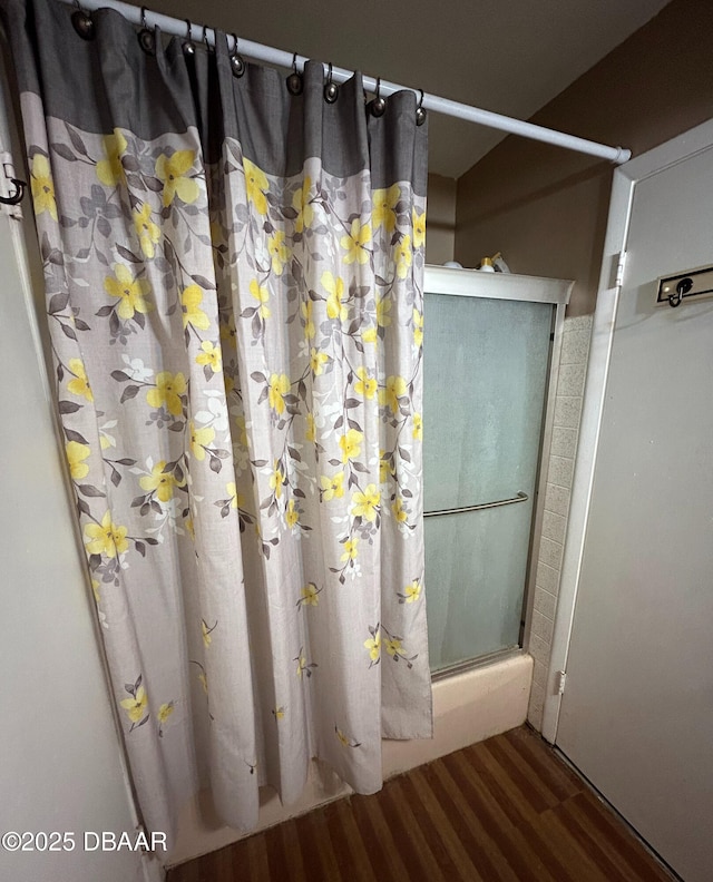 bathroom featuring hardwood / wood-style flooring and walk in shower