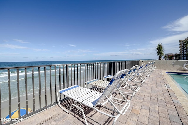 exterior space with a water view and a view of the beach