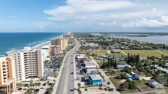 drone / aerial view featuring a water view and a beach view