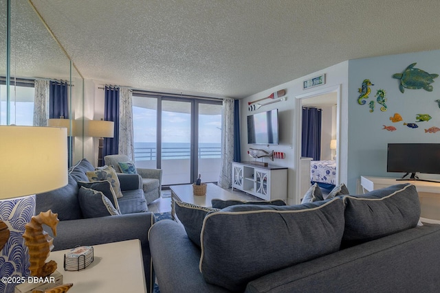 living room with floor to ceiling windows and a textured ceiling