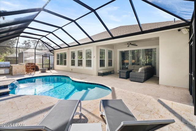 view of swimming pool featuring an outdoor living space, pool water feature, ceiling fan, a patio area, and exterior kitchen