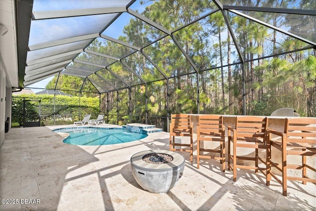 view of swimming pool featuring a lanai, a patio, and an in ground hot tub