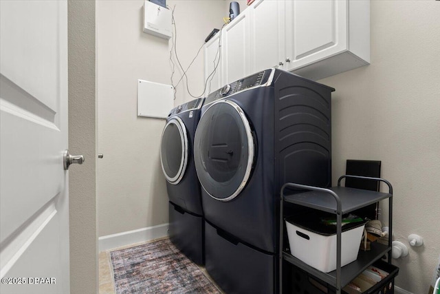 washroom with cabinets and independent washer and dryer